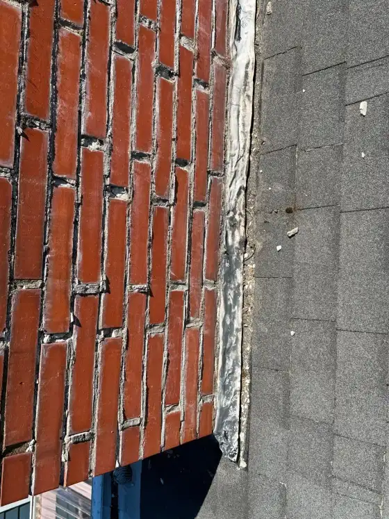 Flashing pulling away from the brick with a gap along the edge