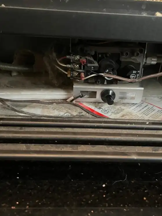 Valve, igniter wiring and pilot assembly under a gas fireplace with dust built up